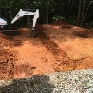 Graded building pad with a Bobcat mini excavator for a couple of horse stables